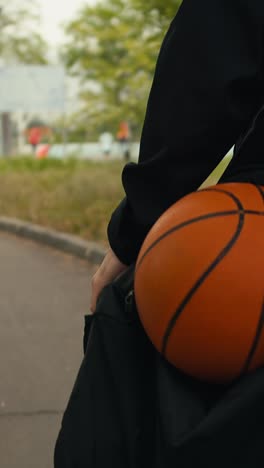 person carrying a basketball