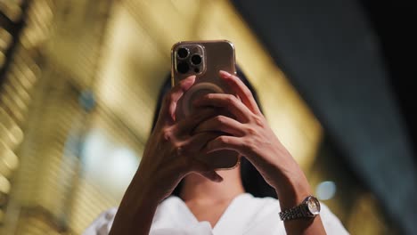 woman taking photo at night