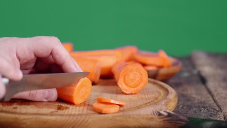 cutting fresh carrots on a cutting board.