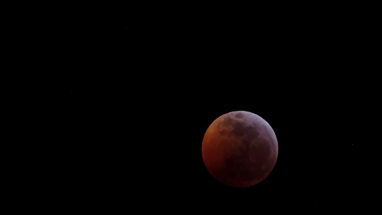 Lunar eclipse in progress against a black sky.