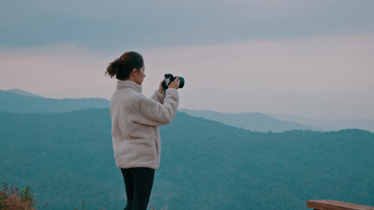 Woman Taking Pictures of Scenic Mountain View