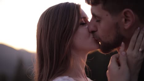 newlyweds. caucasian groom with bride on mountain slope. wedding couple. sunset