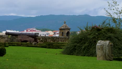 Grassy-lawn-on-tower-with-large-medieval-cannon-resting-on-stone-wall-parapet-in-Chaves-Vila-Real-Portugal