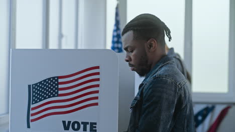 man voting in election booth