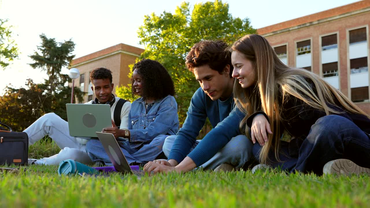 Students collaborating on campus with laptops