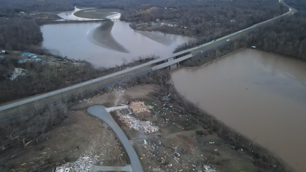 Dramatic aerial zoom into the tornado aftermath of destruction on Lake Barkley, Kentucky. 2021-12-10. Beautiful lake homes were destroyed by a very strong tornado. Dramatic debris trail visible