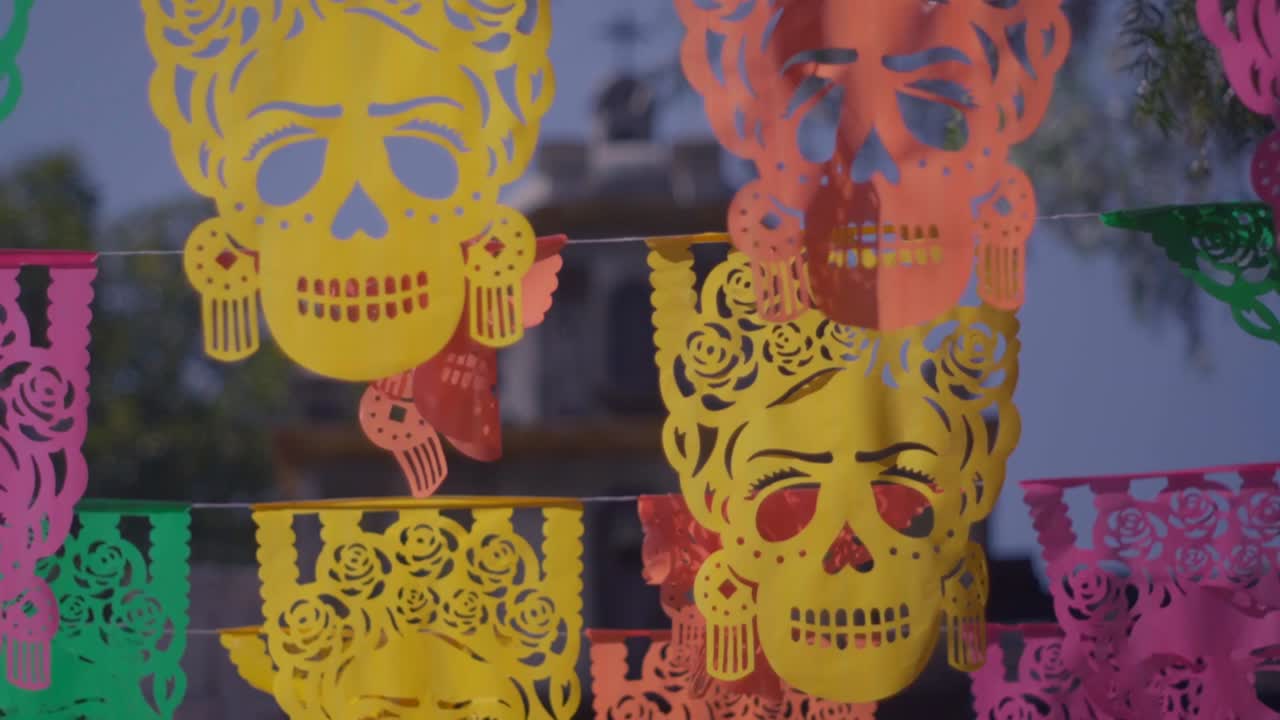 Is a traditional Mexican decorative craft made of intricate cut tissue paper, commonly used during the Día de Muertos (Day of the Dead) celebration.