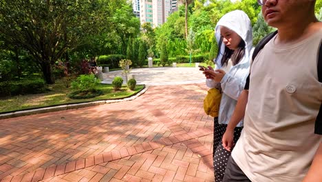 people walking in a lush, urban park setting