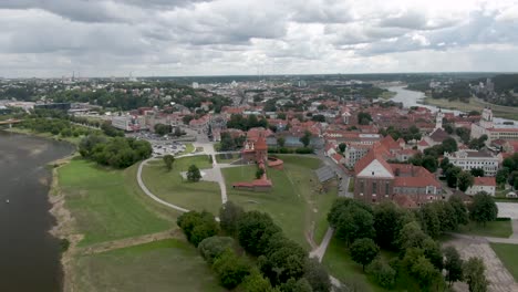 aerial drone shot of castle far side view with city and river in the background. city panorama