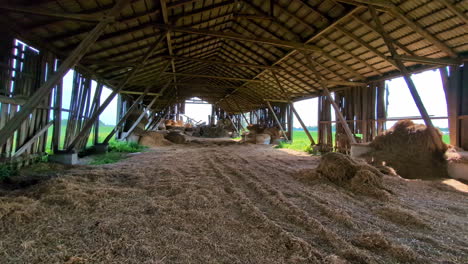 Old-barn-with-leftover-of-hay-after-winter,-panoramic-view