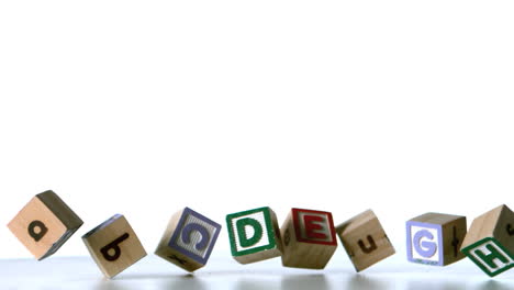 some alphabet blocks falling over