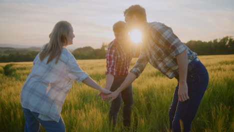 three teenagers high five against sunset background