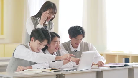 academic team studying on university class, teamwork of teenage students using laptop to prepare exam