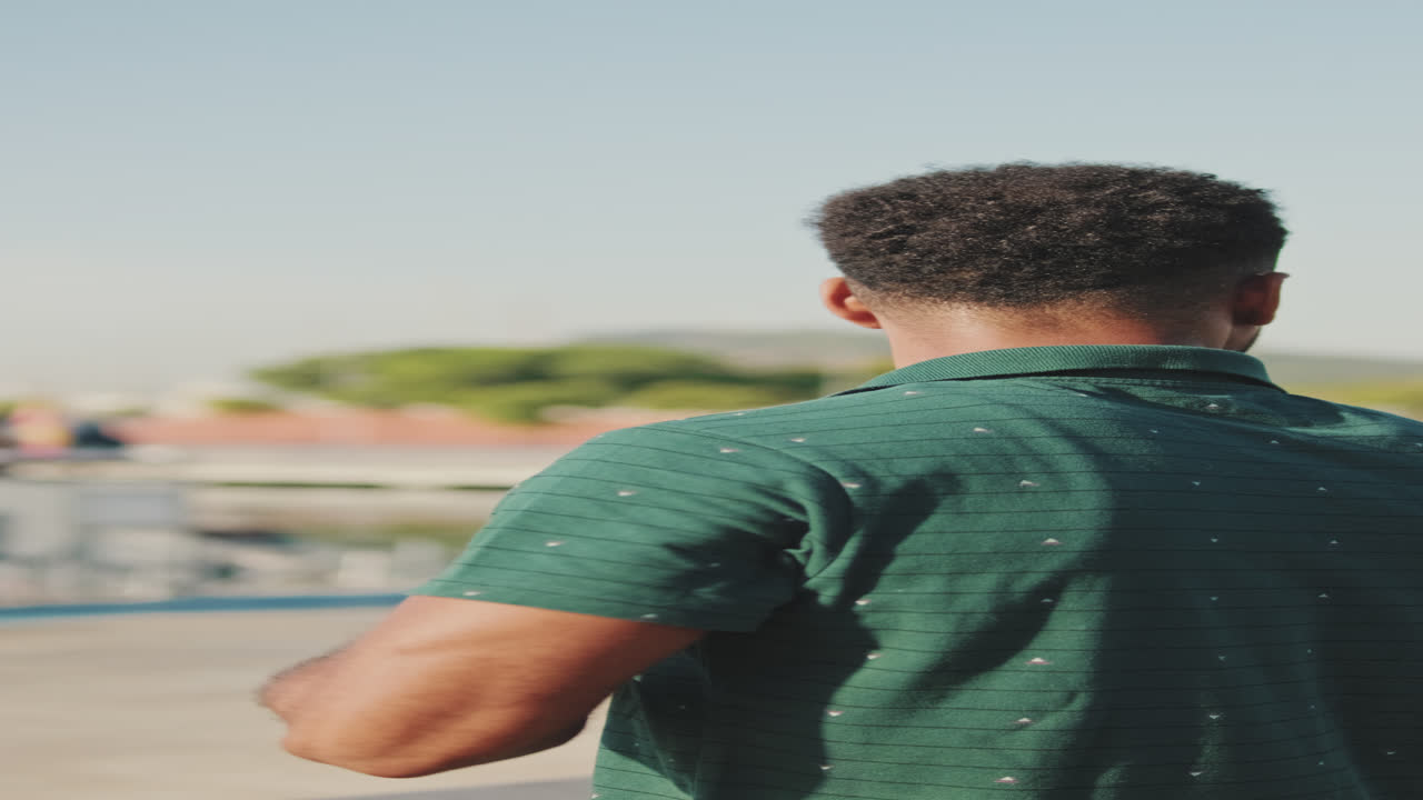 Man in green polo shirt looking at cityscape