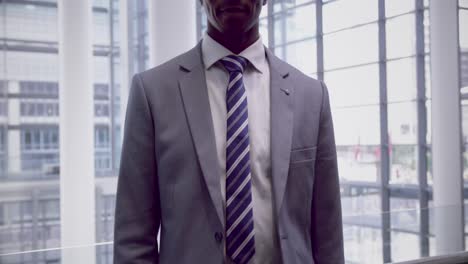 businessman looking at camera in the corridor at office 4k