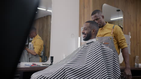 barber giving a haircut to a customer in a modern barber shop.