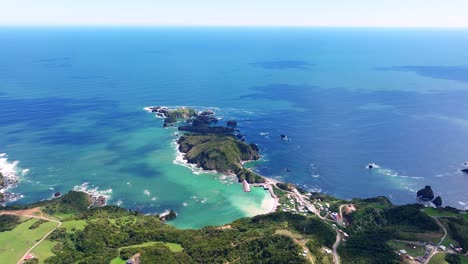 aerial overhead view of estaquilla coastline surrounded by turquoise pacific ocean waters spanning across out to horizon