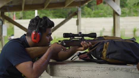 Close-Up-Portrait-Of-A-Man-Shooting-A-Rifle-At-Firing-Range