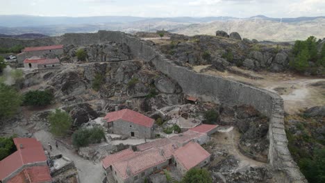 ruins of defensive wall of sortelha fortress surrounding this historic village