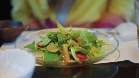 green fresh salad at restaurant, close up 4k shot