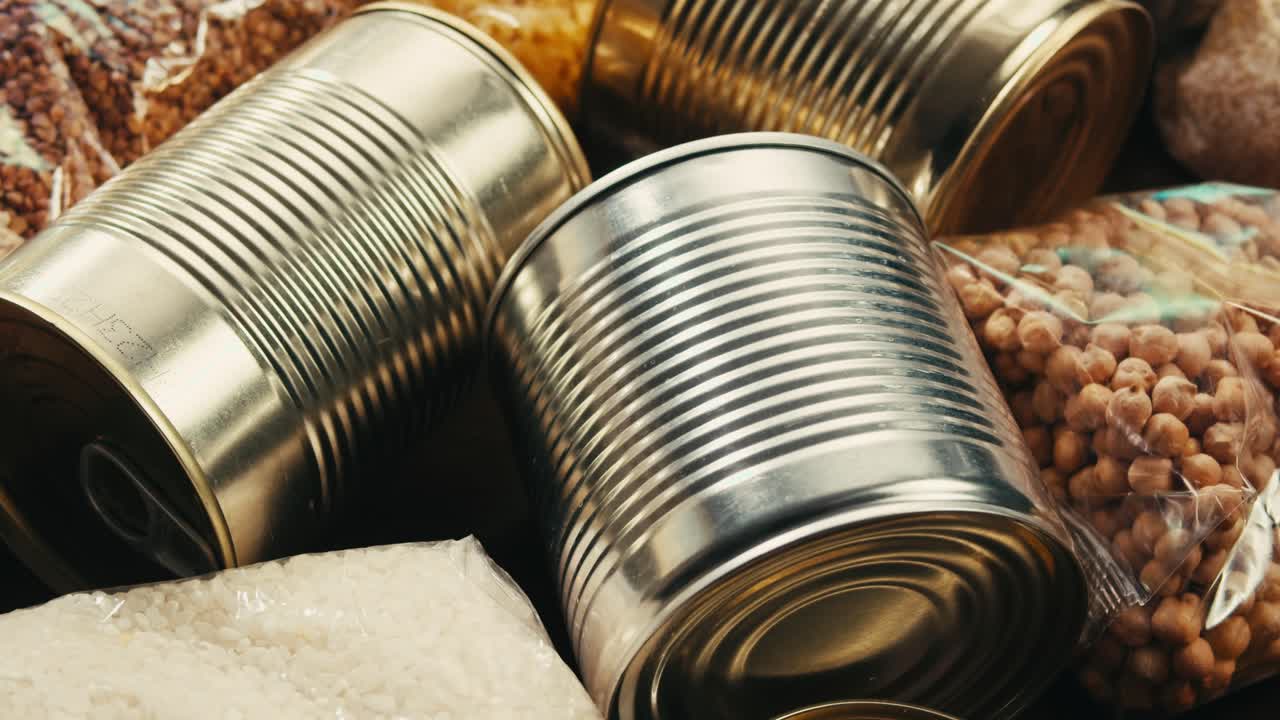 Canned cereals beans fish and vegetables, an assortment of processed foods, supermarket cart online shopping, delivery.