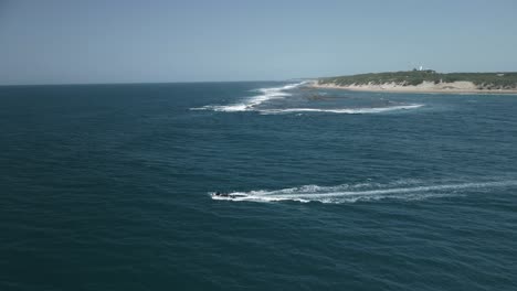 aerial tracking shot of a small boat sailing off the coast of mozambique