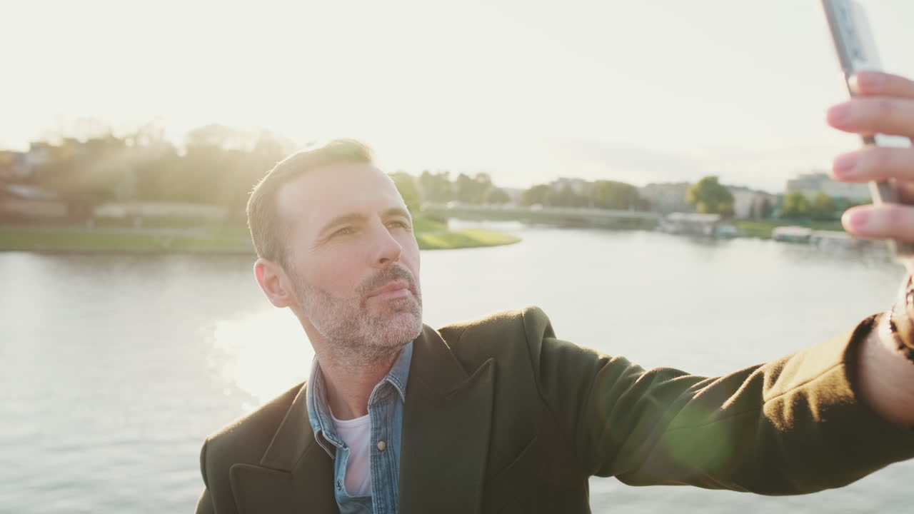 Man Taking a Selfie by the River