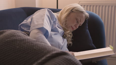 woman sleeping on a couch with a book
