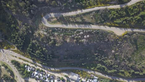 aerial top down view of traffic on zig zag curvy mountainous roads