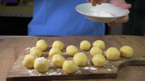 sprinkled flour drop onto dough, woman hand sprinkling sugar powder