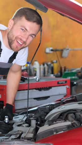male mechanic working on a car engine in an auto repair shop