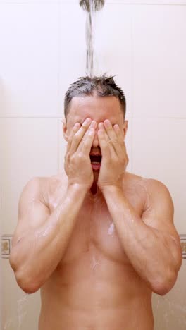 man taking a shower with shampoo