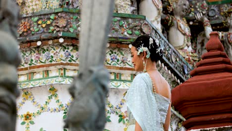 woman in traditional attire at wat arun, bangkok