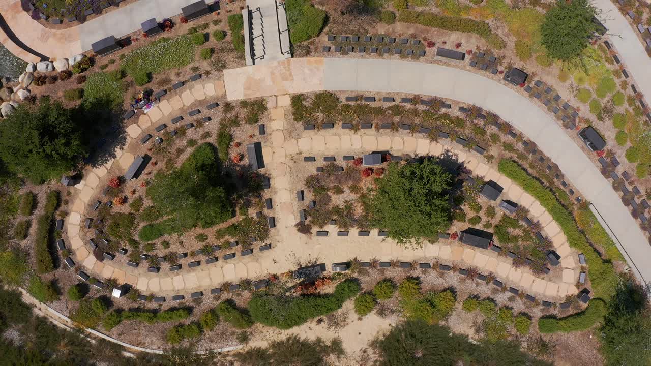 Rising bird's eye shot looking down at a peaceful nature garden at a mortuary in California