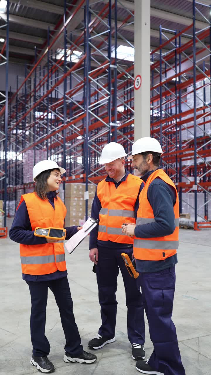 Warehouse workers discussing inventory in a warehouse