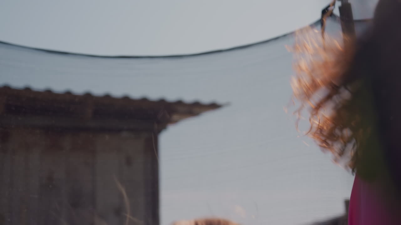 Joyful Family Moment, Mother Spinning Daughter On Bouncing Surface, Happiness Shared Between Mother And Daughter Outside Together, Joyful Scene Where Mother And Daughter Play And Connect Outdoors