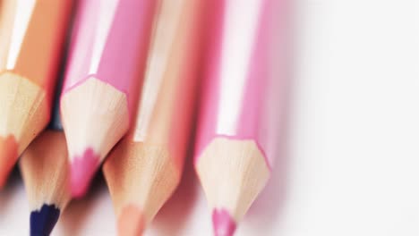 close up of sharpened multi coloured pencils with copy space on white background