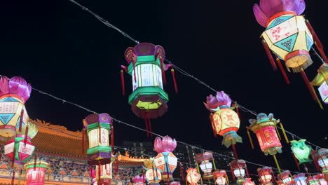 colorful lanterns, which symbolize prosperity and good fortune, hanging from ceiling wires during the mid-autumn festival, also called mooncake festival