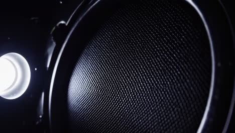 close-up of a speaker grille with bright light