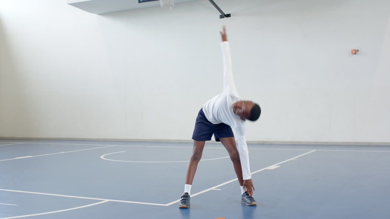 african american boy exercising on basketball court, enjoying physical activity, copy space