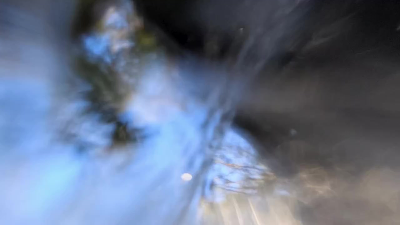 Dynamic low angle shot of water splashing over camera in Blue Mountains National Park, Australia.