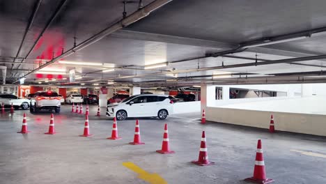 underground parking garage with cars and cones