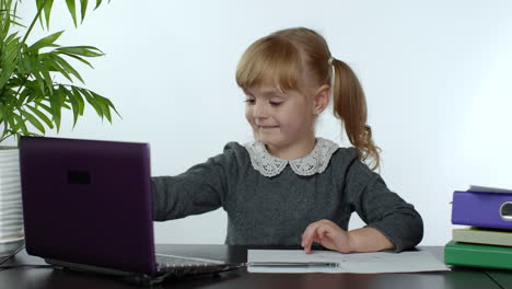 online learning, distance education, lesson at home. girl doing school program online on computer