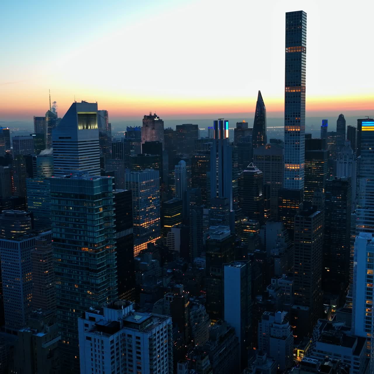 Night slowly falling on the big city. Amazing buildings of New York at the backdrop of sun dusk
