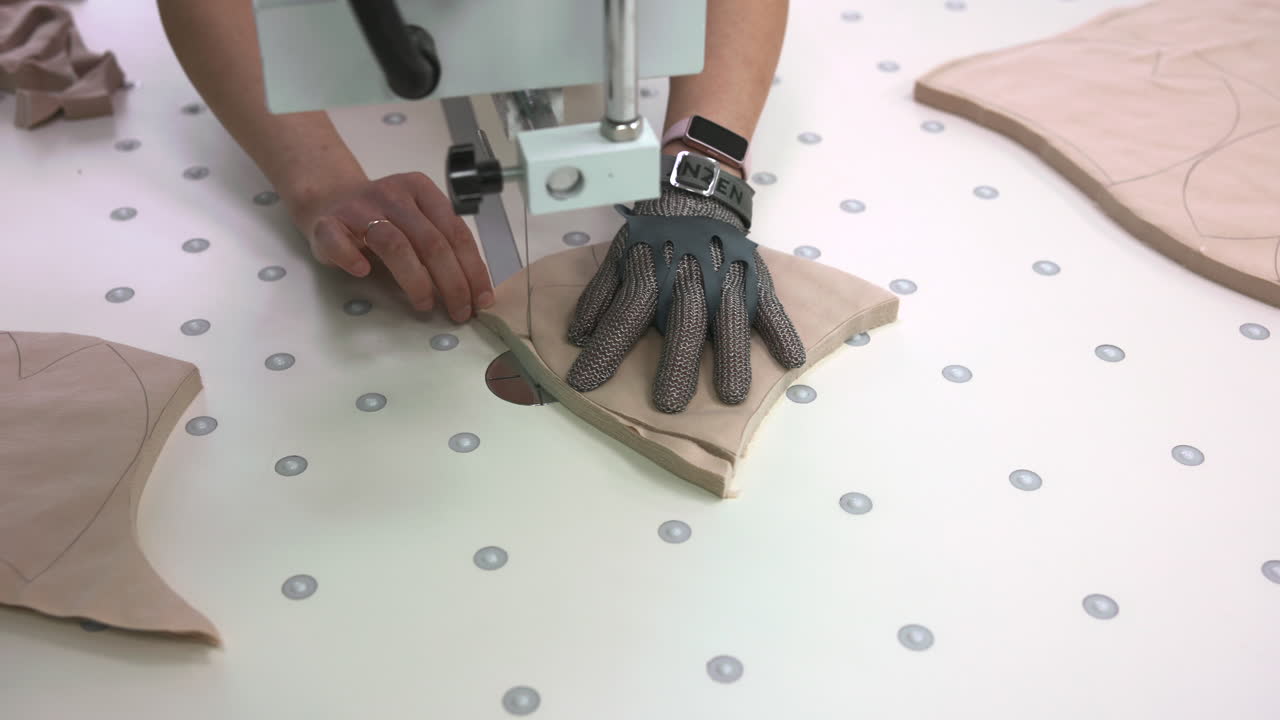 Chainmail Glove Protecting Hand During Cut. Operator Uses Metal Mesh Glove To Shield Fingers While Guiding. Media