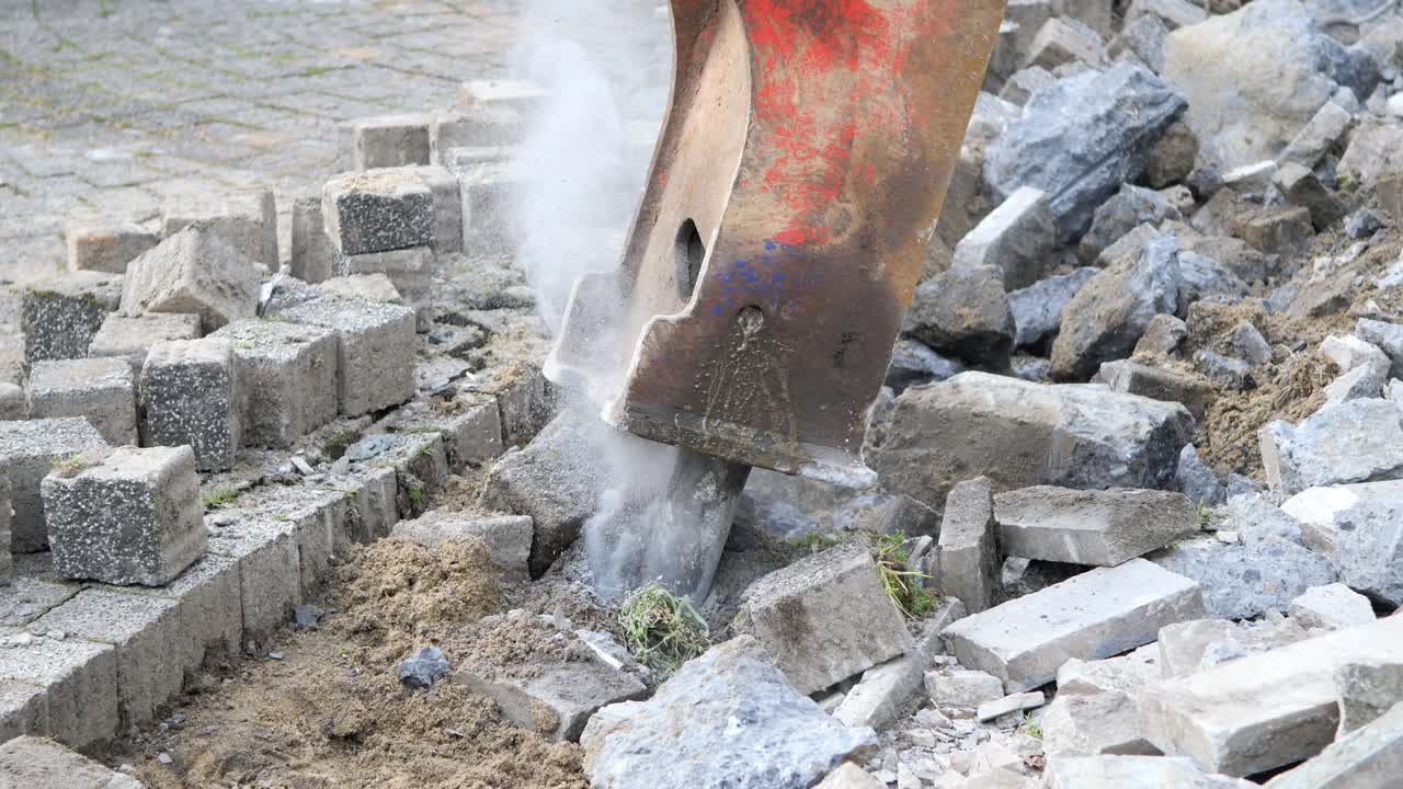 Jackhammer breaking paving stones