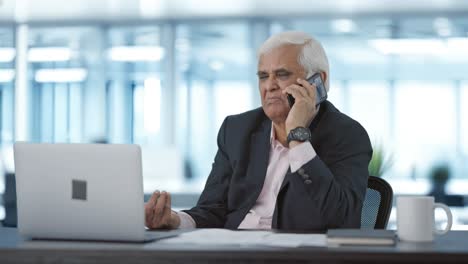 indian senior manager talking on mobile phone