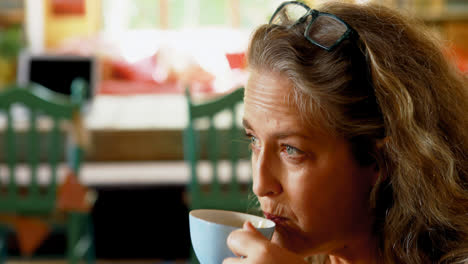 mature woman having coffee at home 4k