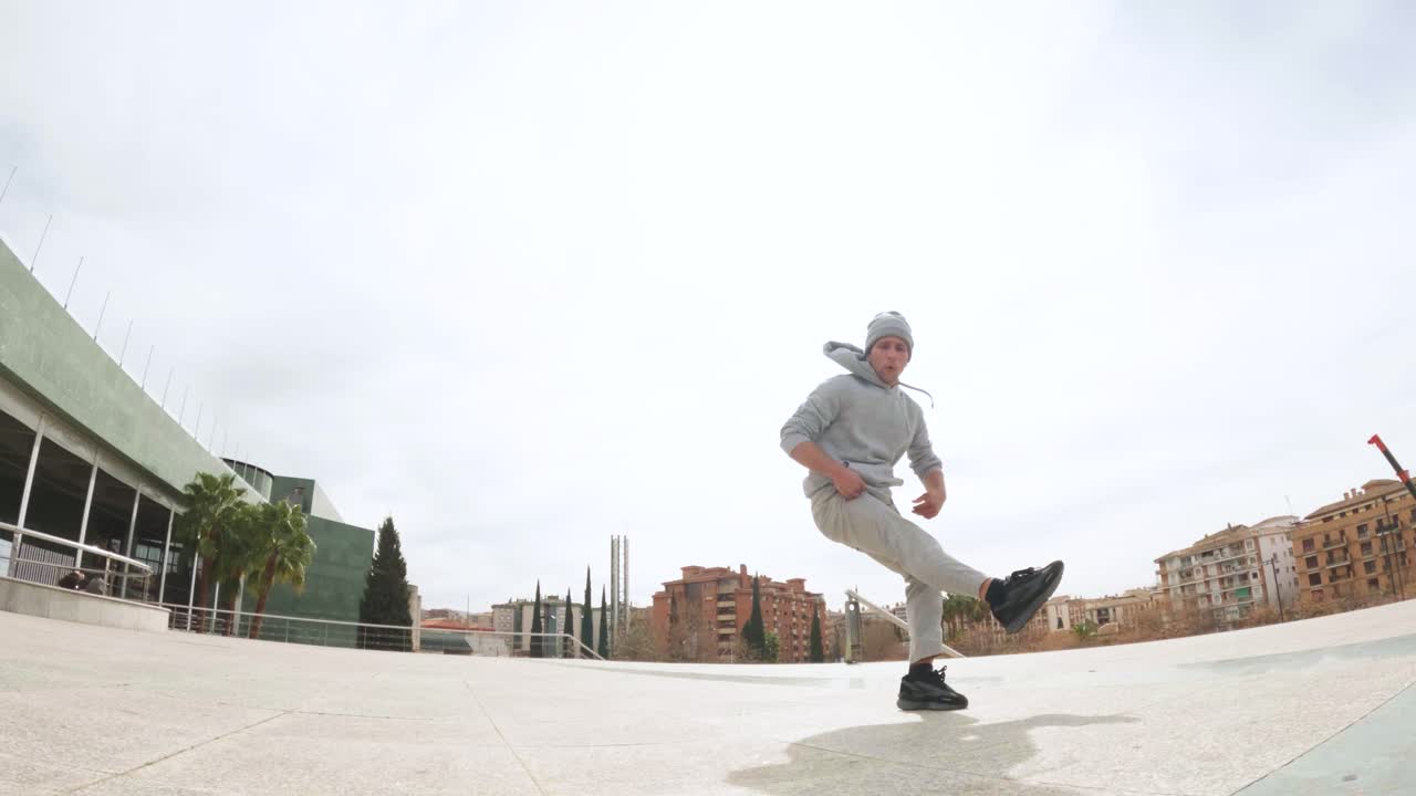 Breakdancer performing cartwheel in urban environment