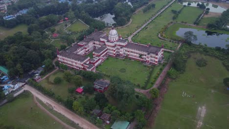 historical monument cooch behar royal palace and museum surrounded by green parks in cooch behar city, west bengal, drone shot